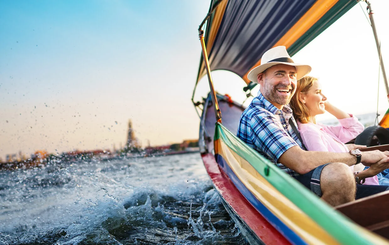 Couple enjoying a sailing trip funded by wedding gifts